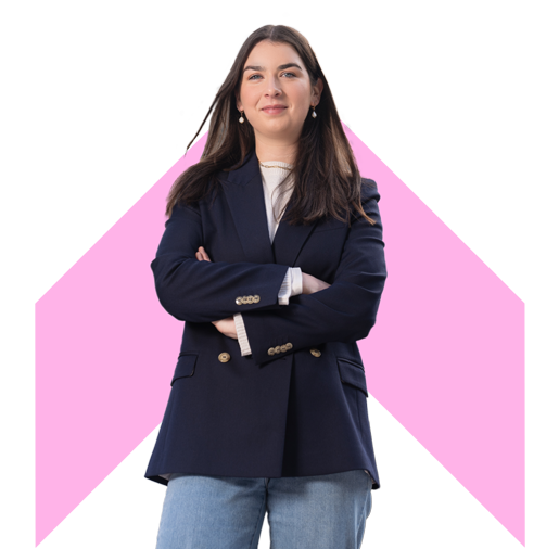 A person with arms crossed with pink chevron background