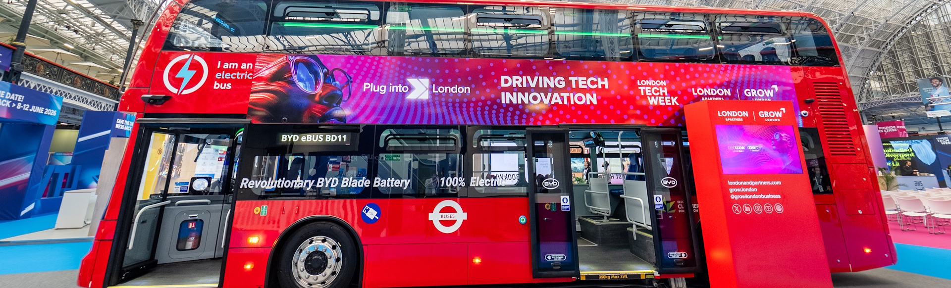 Red double-decker bus on display at London Tech Week at Olympia.