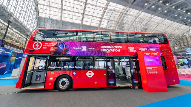 Red double-decker bus on display at London Tech Week at Olympia.