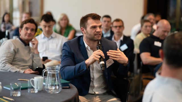 A man talking at a business event.