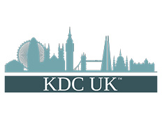 'KDC UK' written in white letters inside green rectangle with image of the London skyline above.