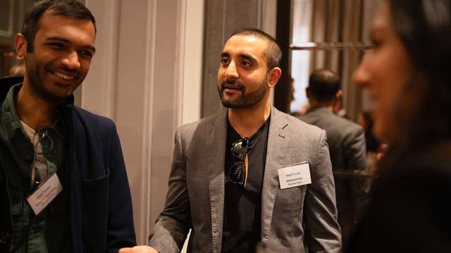 A group of people networking at a business event.