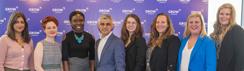 The Mayor of London and a group of people stand in a line and smile at the launch event 