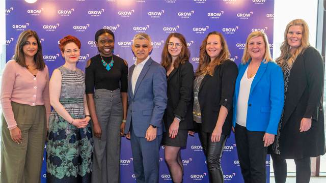 The Mayor of London and a group of people stand in a line and smile at the launch event 