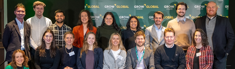 Team of Grow London Global programme lined for a group picture in front of a green board with Grow London Global written all over it.