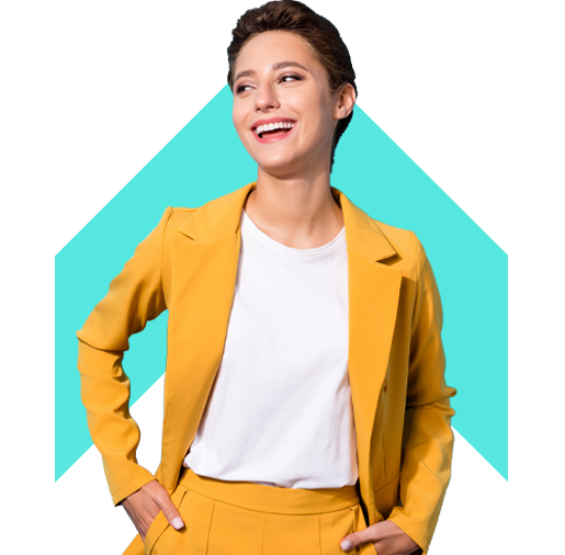 Smiling lady in mustard coloured jacked standing with hands in pockets.