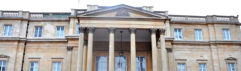 Exterior of a neo-classical style building with columns at the front. 