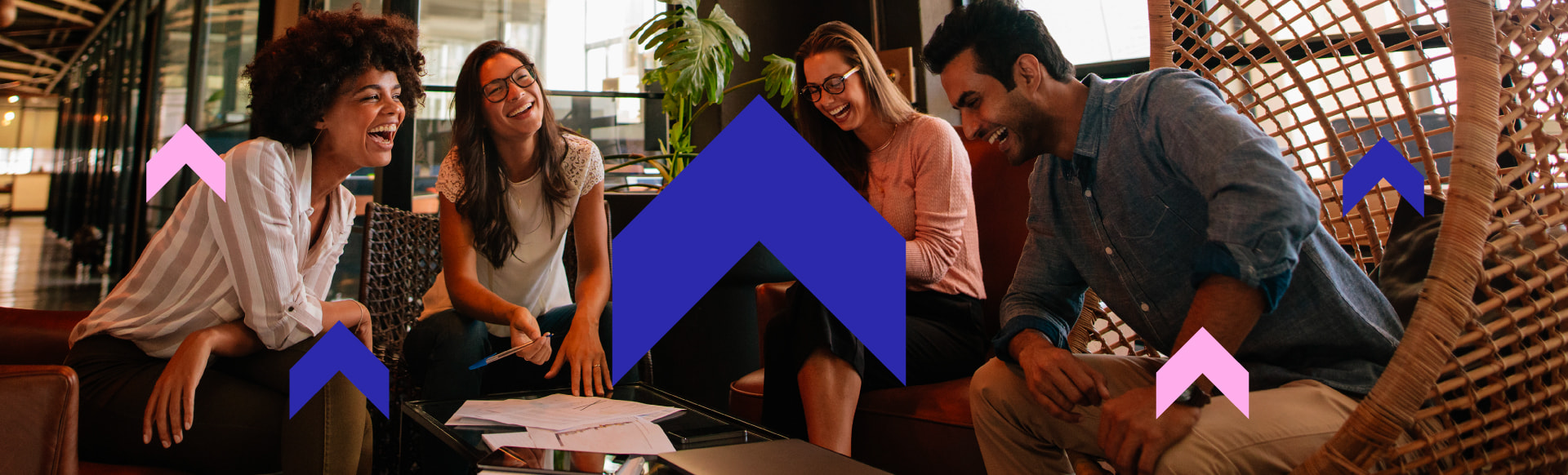 Group of people smiling and laughing while having a meeting