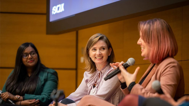 Three panelists talking in a conference.