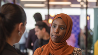 Two women talking at a business event