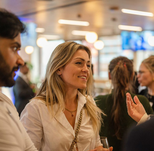 Woman talking with other people at a business event.