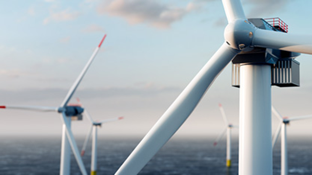 An aerial view of several wind turbines