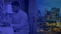 A scientist working with a view of London's skyscrapers.